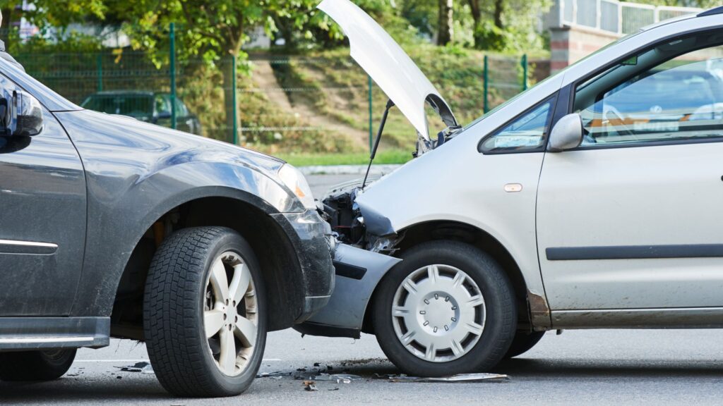 A head-on collision between two vehicles with visible damage, representing a case for a Gulfport Head-On Collision Lawyer from HFFR Injury Attorneys.